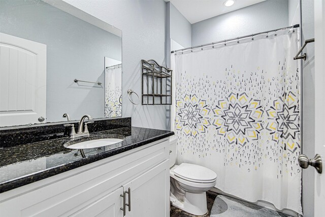 bathroom featuring vanity and toilet