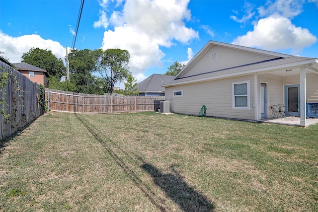 view of yard with central AC, a patio area, and a fenced backyard