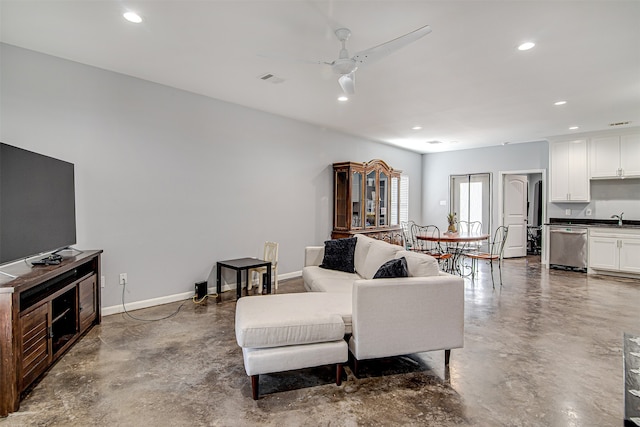 living room featuring sink, concrete flooring, and ceiling fan