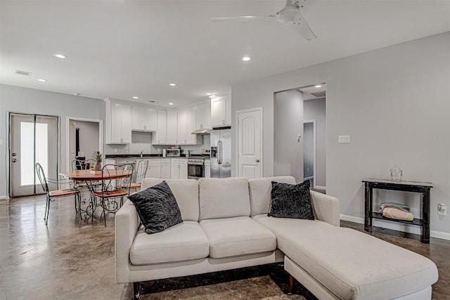 living room featuring finished concrete flooring, recessed lighting, visible vents, a ceiling fan, and baseboards