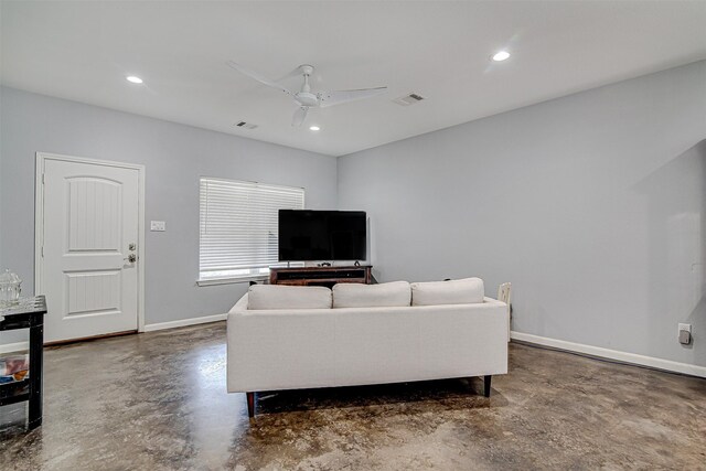 living room with concrete flooring and ceiling fan