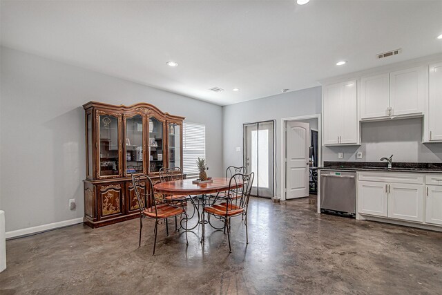 dining area with concrete floors and sink