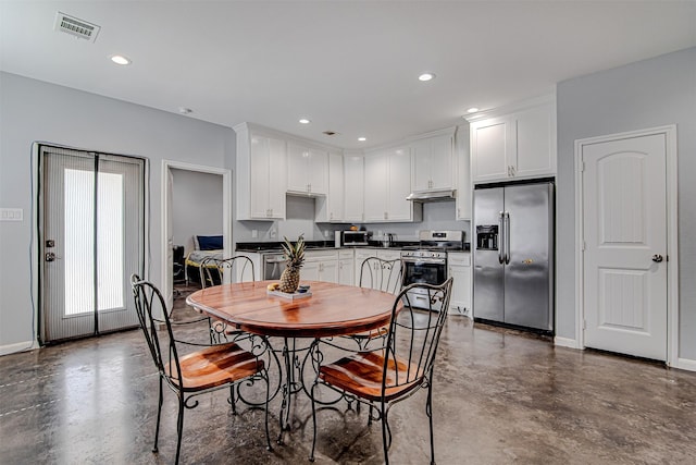 dining area with concrete flooring, recessed lighting, and visible vents