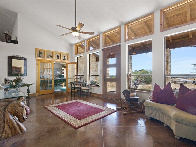 living room with high vaulted ceiling, ceiling fan, and french doors