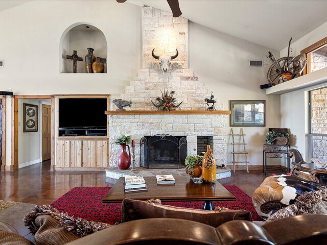 living room featuring a fireplace and high vaulted ceiling