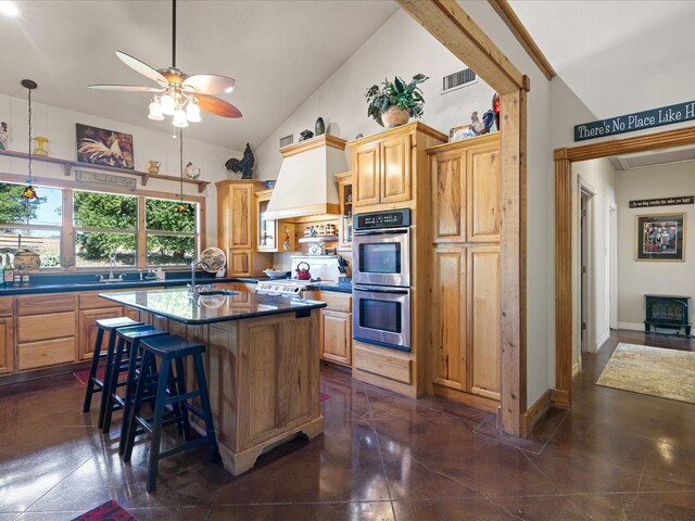 kitchen featuring sink, a center island with sink, high vaulted ceiling, double oven, and a breakfast bar area