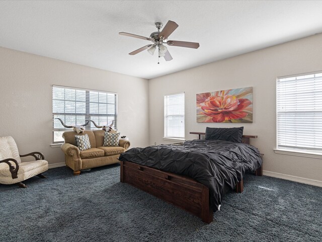 carpeted bedroom with ceiling fan and multiple windows