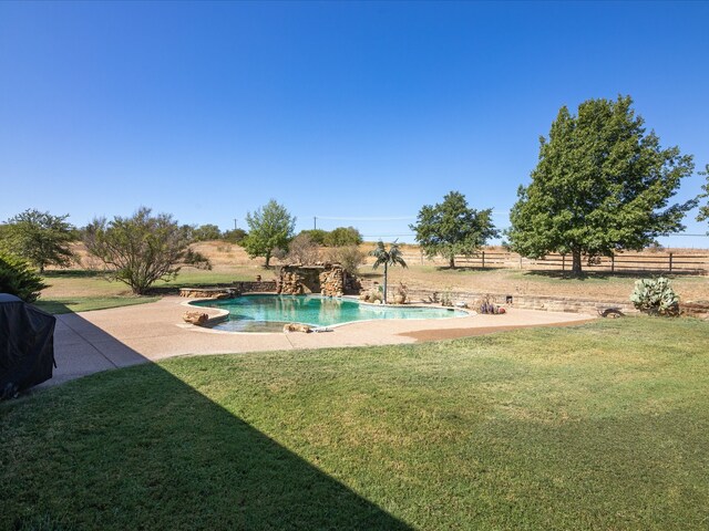 view of pool with a lawn and a patio