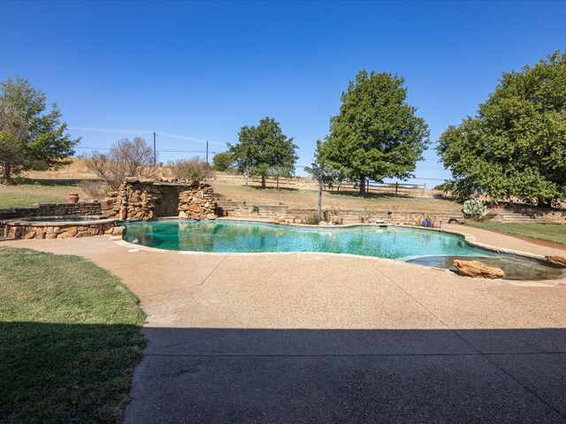 view of pool featuring a yard and a patio area