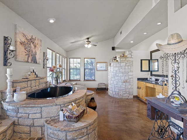 kitchen featuring ceiling fan, light brown cabinetry, sink, and vaulted ceiling