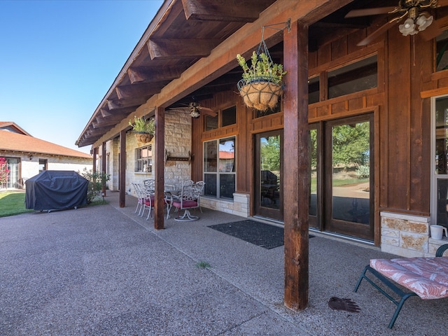 view of patio featuring ceiling fan and a grill