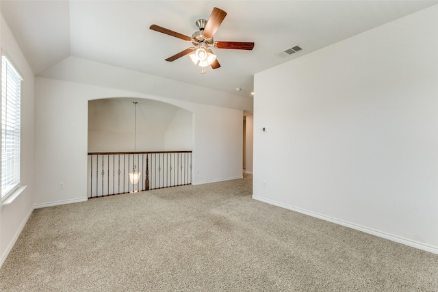 carpeted empty room featuring ceiling fan and vaulted ceiling