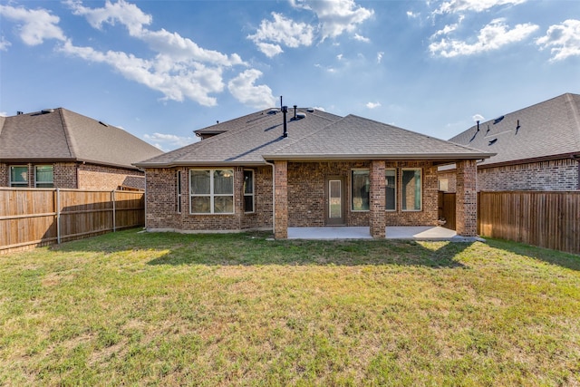 rear view of house featuring a patio area and a lawn