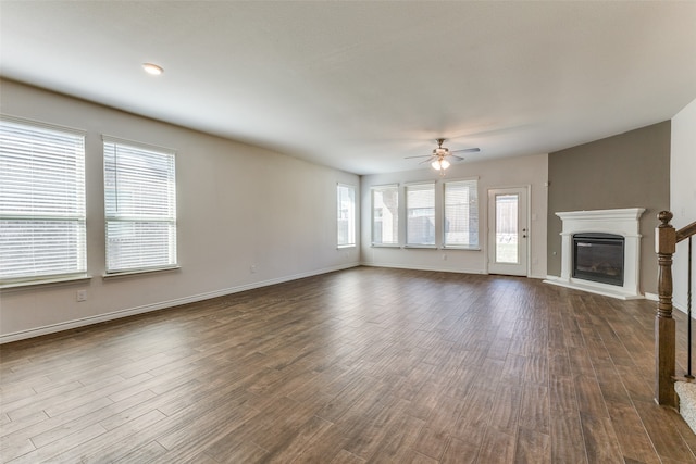 unfurnished living room with hardwood / wood-style flooring, ceiling fan, and plenty of natural light