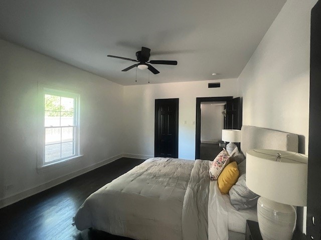 bedroom with ceiling fan and dark hardwood / wood-style flooring