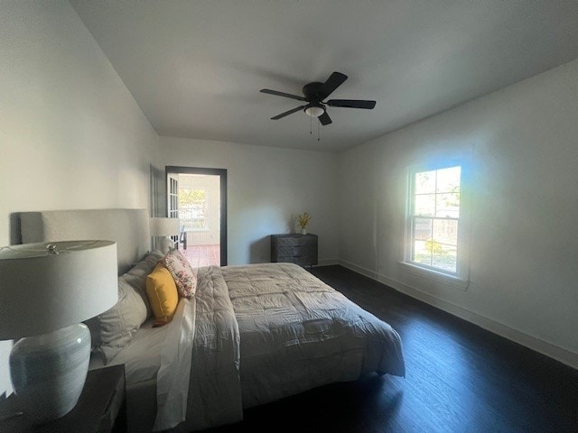 bedroom with ceiling fan and dark wood-type flooring