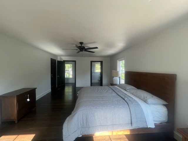 bedroom with ceiling fan and dark wood-type flooring