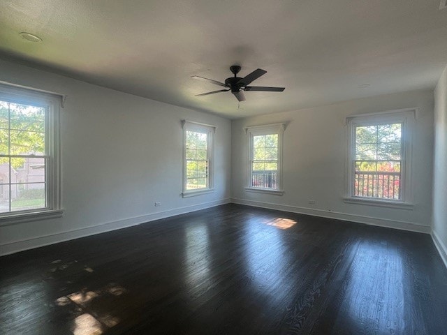 spare room featuring ceiling fan and dark hardwood / wood-style floors