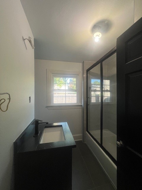 bathroom featuring shower / bath combination with glass door and vanity