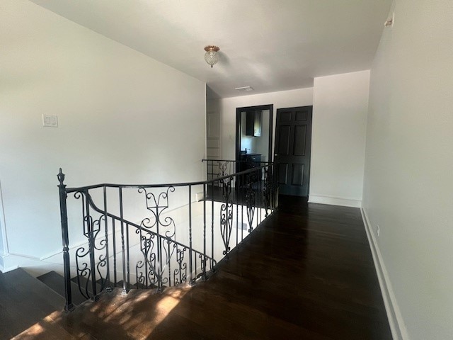 hall with dark hardwood / wood-style floors