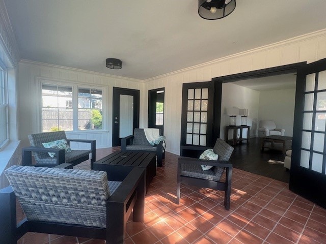 tiled living room featuring french doors and ornamental molding