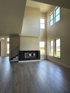 unfurnished living room featuring dark wood-type flooring