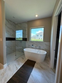 bathroom with tile flooring and tile walls