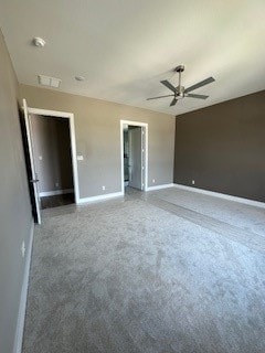 carpeted spare room with ceiling fan