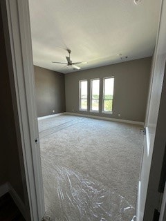 unfurnished room featuring carpet floors and ceiling fan