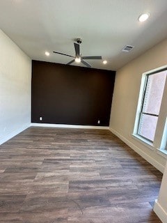 empty room with dark wood-type flooring and ceiling fan