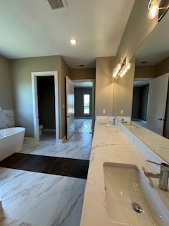 bathroom with dual vanity and tile flooring