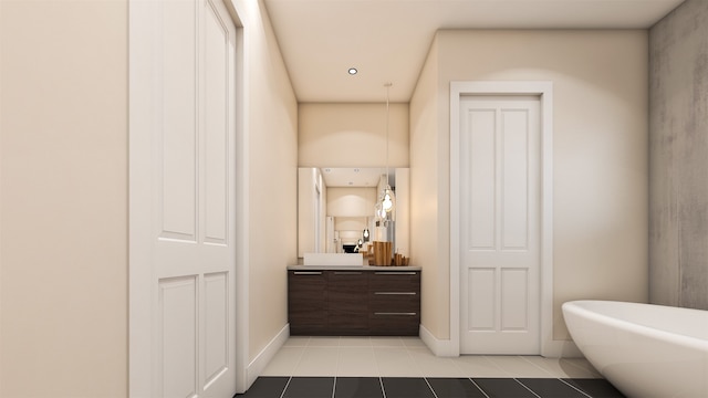 bathroom featuring tile floors, a tub, and vanity