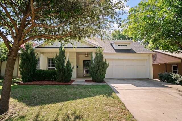 view of front of property featuring a garage and a front lawn