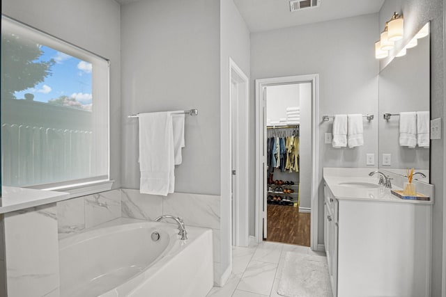 bathroom with vanity and a bathing tub