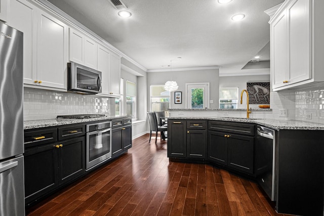 kitchen with stainless steel appliances, white cabinetry, sink, and crown molding