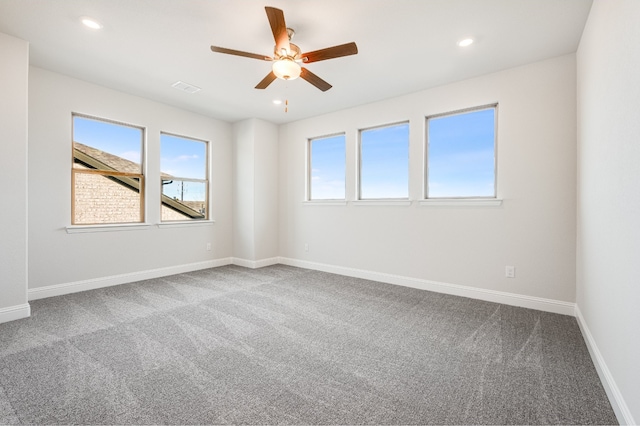 carpeted spare room with ceiling fan