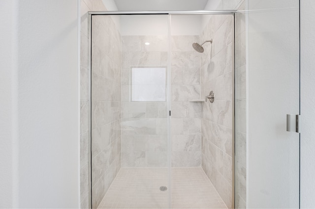 bathroom with a shower with door