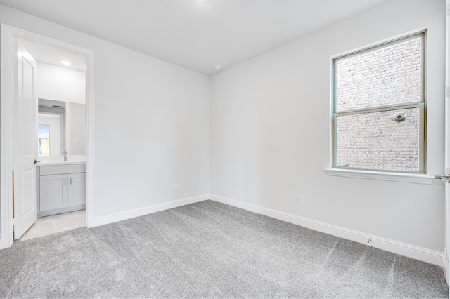 carpeted empty room with a wealth of natural light