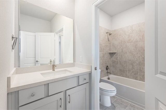 full bathroom with tile patterned flooring, vanity, toilet, and tiled shower / bath