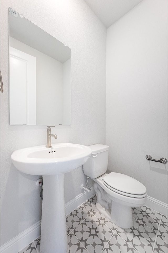 bathroom with sink, tile patterned flooring, and toilet