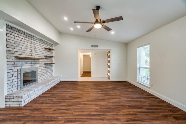 unfurnished living room featuring vaulted ceiling, a brick fireplace, ceiling fan, and dark hardwood / wood-style floors