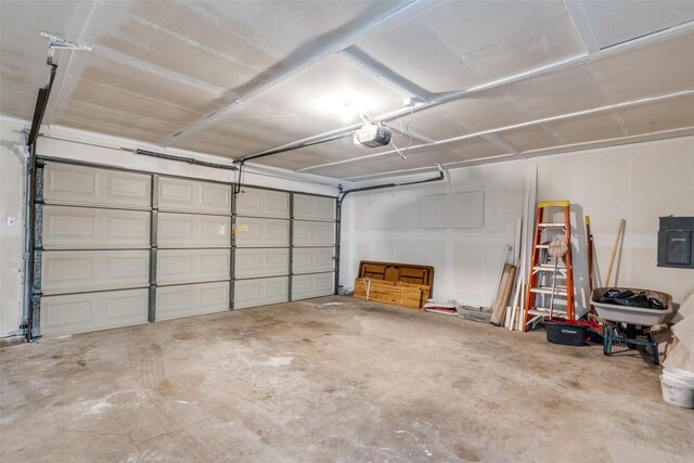 garage with electric panel and a garage door opener