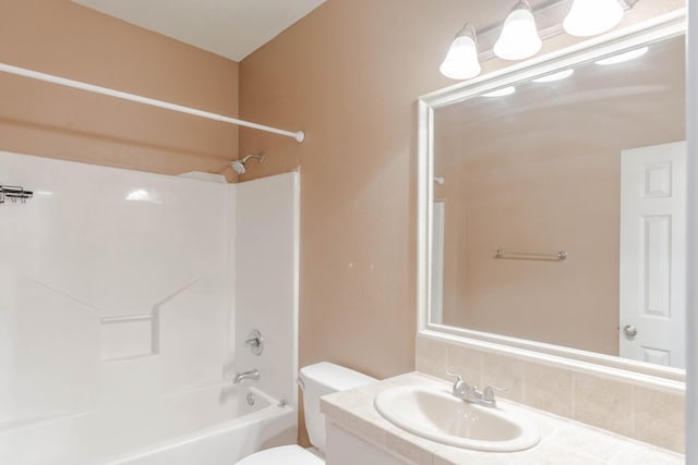 bathroom with shower / bathing tub combination, vanity, and toilet