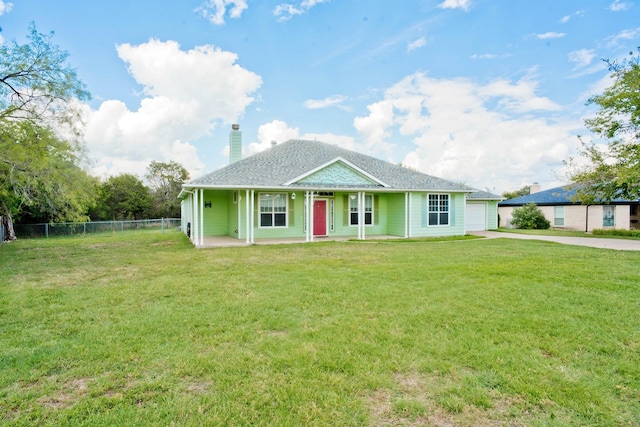 view of front of property featuring concrete driveway, a front lawn, a chimney, and fence