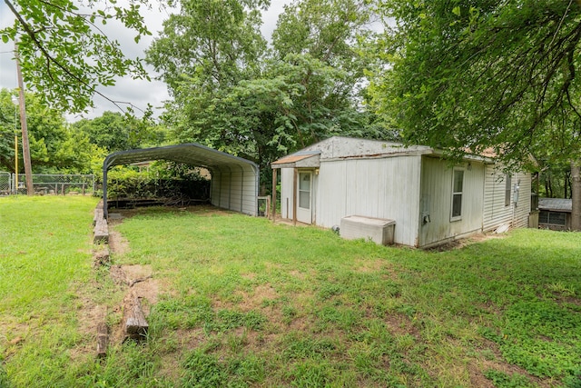 view of yard with an outdoor structure and a carport