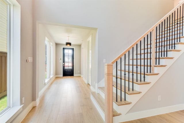 entryway featuring light wood-type flooring and a healthy amount of sunlight