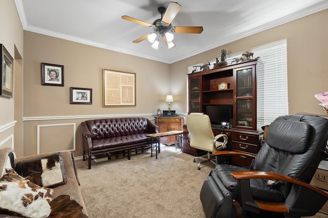 office area with carpet flooring, ceiling fan, and ornamental molding