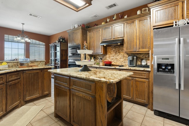 kitchen featuring an inviting chandelier, gas stovetop, built in microwave, light tile patterned flooring, and stainless steel fridge with ice dispenser