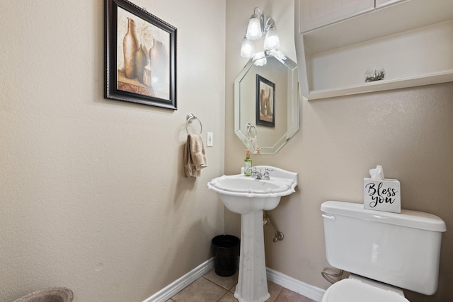 bathroom with tile patterned flooring, toilet, and sink