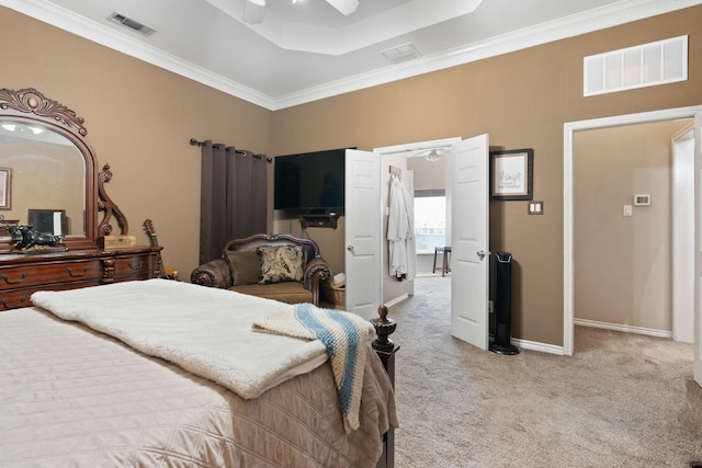 bedroom featuring a tray ceiling, ceiling fan, crown molding, and light carpet